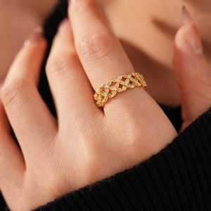 Detail of 18k gold plated hollow flower ring with cubic zirconia stones on hand