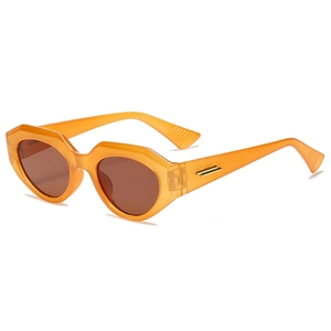 Fashionable orange translucent cat eye sunglasses with geometric frames and gold metal accents