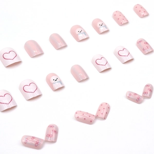 Cute pink and white press-on nails featuring snowman heart and polka dot art designs