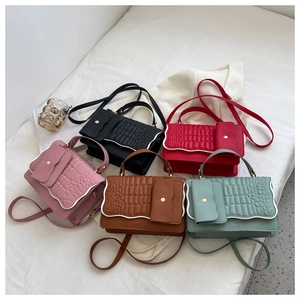Group shot of colorful pleated mini crossbody bags with crocodile embossed texture