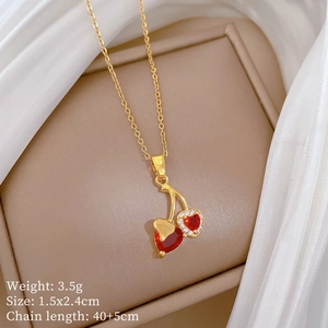 Detailed shot of cherry pendant necklace with red heart crystals and micro-inlaid stones