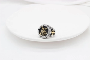 Detailed close-up of St. Michael vintage stainless steel ring with golden cross accents