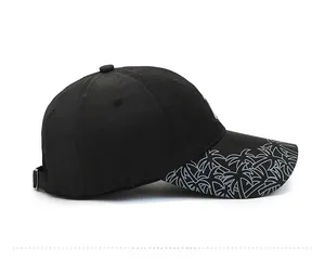 Side view of black quick-dry sun hat with palm leaf print on the brim and metal buckle
