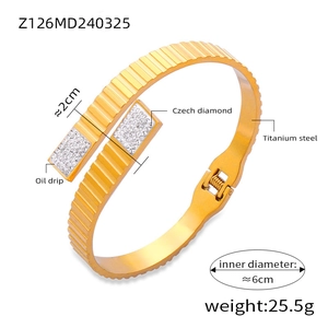Detailed macro view of gold titanium steel bangle with gear edge and Czech diamonds