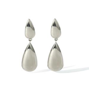 Macro shot of silver teardrop earrings with a polished finish and streamlined metal curves