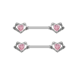Detailed view of silver skeleton hand nipple rings with pink heart-shaped zircons