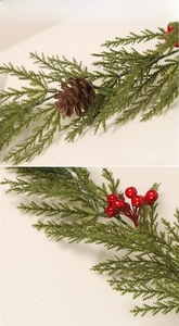 Macro detail of Christmas pine garland with green needles, brown cones and red berries