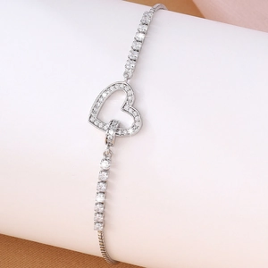 Macro detail of silver heart bracelet with white cubic zirconia micro-pave setting