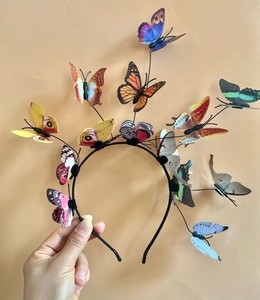 Detail of a headband featuring colorful 3D butterflies for parties and Christmas