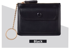 Detail of black faux leather coin purse featuring gold zipper and keychain hardware