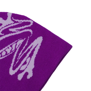 Detailed close-up of dark purple knitted beanie fabric showing fine abstract patterns