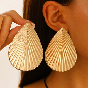 Chunky gold banana leaf teardrop earrings with radial texture for a bold fashion look