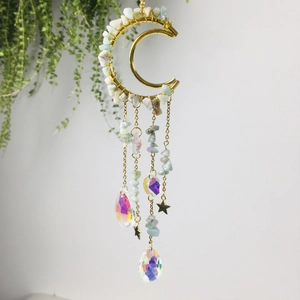 Detail of golden moon suncatcher with amethyst stones and teardrop crystal prisms