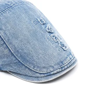 Retro washed blue denim duckbill cap with white stitching and distressed brim detail