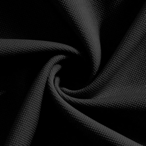 Macro shot of black knitted fabric texture showing detail of breathable polo shirt material