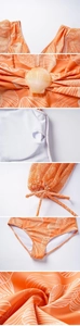 Detail view of orange shell print swimsuit with mesh puff sleeves and pearl clasp