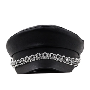 Chic black PU leather baker boy hat with double silver chain detail on white background