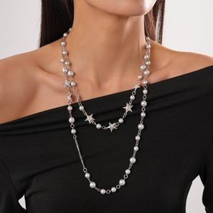 Elegant layered long necklace featuring white faux pearls and textured star pendants