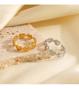 Detailed view of connected heart-shaped open rings in gold and silver plating