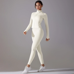 Detail of cream white yoga set with zip-up jacket, thumbhole cuffs and high-waist leggings