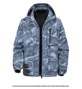 Detail of blue camouflage jacket featuring large utility pockets and Dear woven label