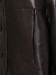 Detailed close-up of dark brown leather jacket featuring large patch pockets and plush lining