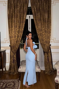 Detail of light blue halter neck evening dress showing backless cut and slim fishtail hem