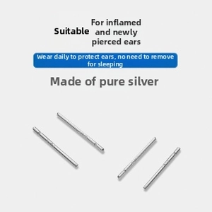 Detail view of four minimalist S999 sterling silver ear studs for healing piercings