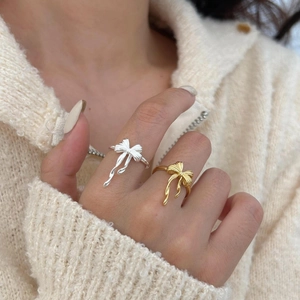 Elegant 925 sterling silver bow knot open rings in gold and silver finish on hand
