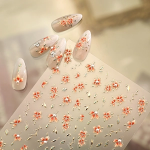 Vintage floral nail stickers with orange petals, gold edges and 3D pearls on nude nails