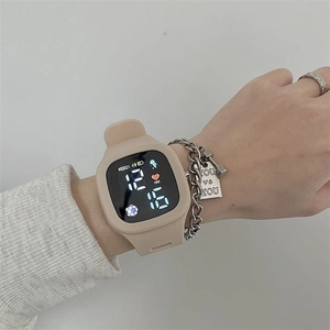 Beige LED digital sports watch with square touch screen and silicone strap on wrist