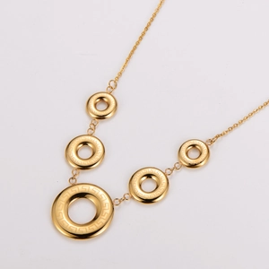 Minimalist gold stainless steel necklace with five hollow circles featuring fret patterns