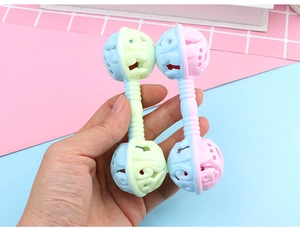 Detail of macaron-colored double-headed baby rattle with non-slip textured handle
