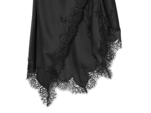 Detailed close-up of premium black silk satin fabric with elegant eyelash lace trim