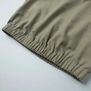Detailed macro view of olive green cotton linen fabric with elastic pleated waistband