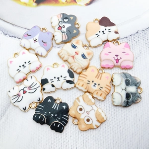 Macro view of assorted enamel cat charms in various colors for DIY jewelry making