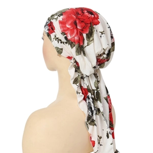 Detailed back view of a white floral headscarf with large red roses on a model