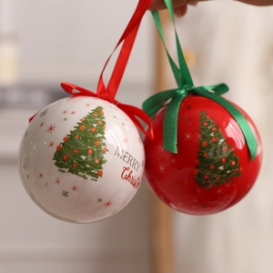 Red and white Christmas balls with trees and Merry Christmas text hanging on ribbons