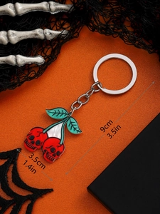 Detail of red skull cherry keychain with green leaves and 9cm length measurement specs