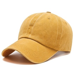 Detailed view of ginger yellow washed cotton fabric and stitching on baseball cap