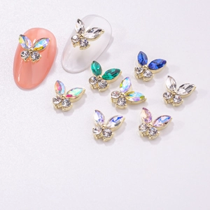 Detailed view of colorful 3D butterfly nail charms with crystal rhinestones and gold alloy