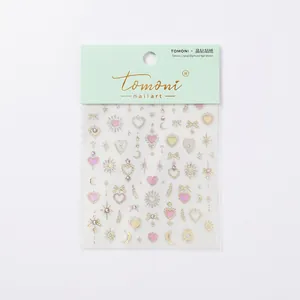 Sparkling crystal 3D nail art stickers with heart moon and butterfly designs in gold