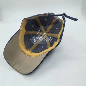 Inside view of dark blue denim baseball cap with USA letters and metal strap adjustment