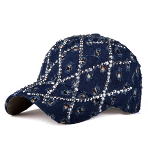 Vista dettagliata del cappello di jeans blu scuro con strass argentati e fori effetto usurato