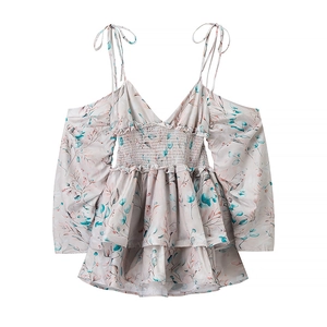 Floral cold-shoulder blouse with smocking waist and ruffle cuffs on white background