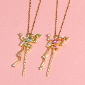 Vue détaillée de colliers papillon dorés avec zircons roses et verts et perles fines