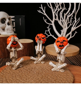 Detailed view of pumpkin-headed skeletons in hear-see-speak no evil poses for Halloween