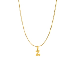 Macro detail of golden letter Z pendant on a fine bead chain stainless steel necklace