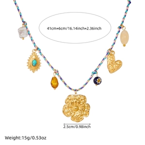 Detailed view of bohemian woven necklace with colorful cord and gold floral charms