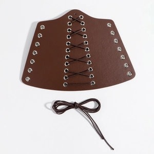 Detail of vintage medieval faux leather bracers in dark brown with metal eyelets and laces